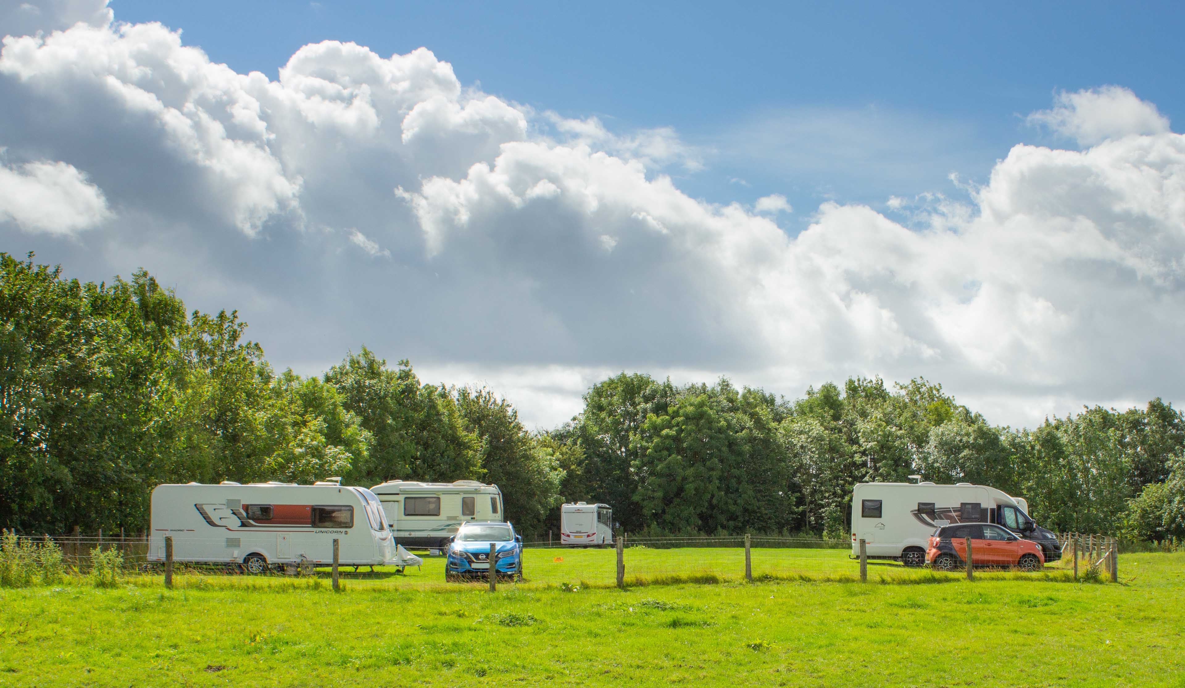 The view up the lawn finished Church Farm Caravan and Motorhome site providing space for up to 5 caravans.