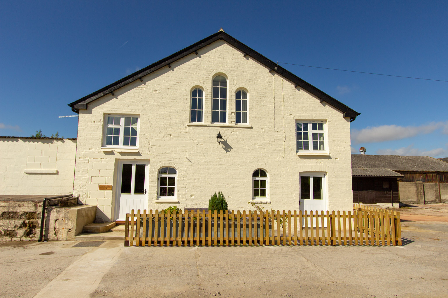 The front of Old Dairy Cottage Holiday Let. The garden bench offeres views over the fields perfect for a morning coffee.